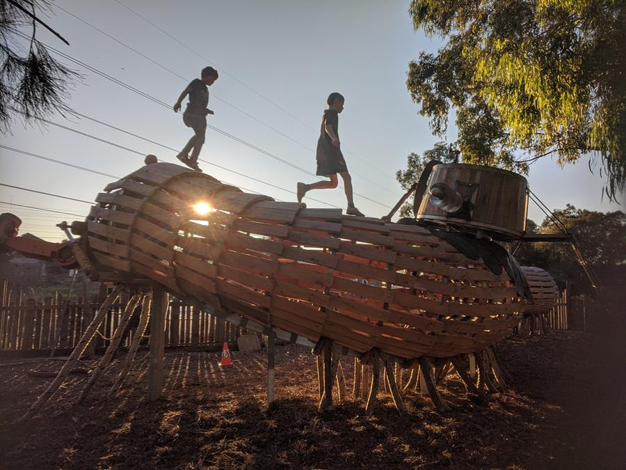 TerraWonder_millipede_sunset-full - CERES Fair Food Terra Wonder Playspace CERES Millipede Playground at sunset with young people running across the sculpture